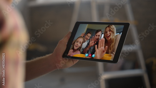 Remote family waving online in tablet home closeup. Unknown man hands hold pad