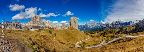 Panorama of the Dolomites mountains on a sunny day, blue sky with soe clouds. Beautiful mountians of Alpi Dolomiti in Italy, South Tirol alpine range in autumn photo