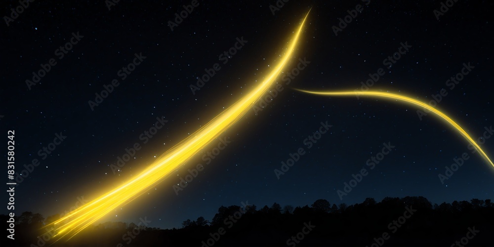 luminous glowing yellow trail of shooting star on a dark night sky