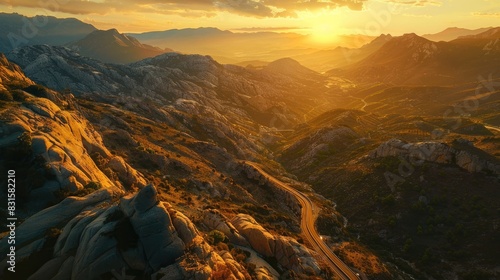 Stunning aerial view captures rocky mountains with towering stones road winding through the mountains under a beautiful sunset photo
