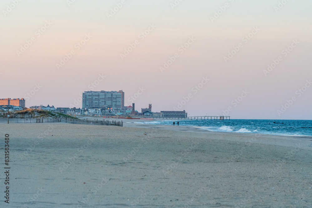 Avon By the Sea, New Jersey, USA - Golden hour sunrise on the beach looking north toward Ocean Grove and Asbury Park Avon By the Sea, New Jersey, USA - Golden hour sunrise on the beach looking north toward Ocean Grove and Asbury Park