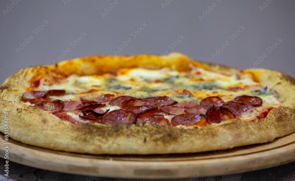 Traditional Brazilian style pizza, half flavored with four cheeses and half pepperoni on long-matured artisanal dough Traditional Brazilian style pizza, half flavored with four cheeses and half pepperoni on long-matured artisanal dough