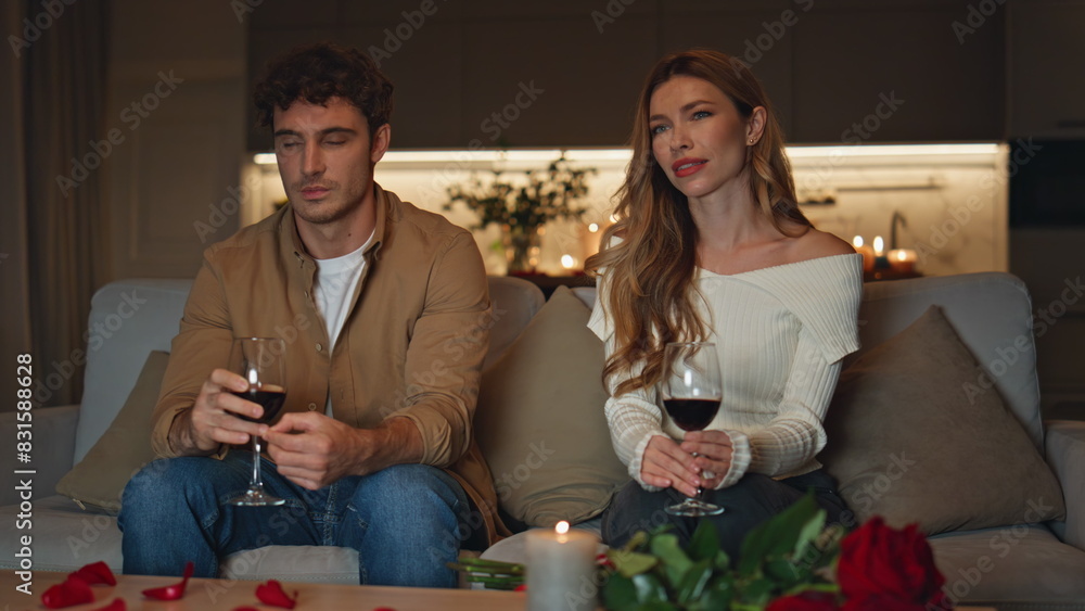Shying couple having date in cozy evening apartment. Cute pair spending evening Shying couple having date in cozy evening apartment. Cute pair spending evening