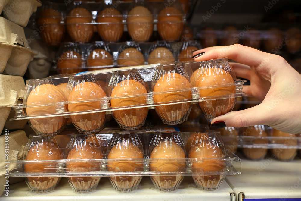 A person is reaching for a carton of eggs A person is reaching for a carton of eggs