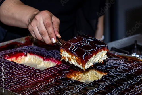 Chef prepares trilece dessert in the kitchen. Turkish Traditional Trilece - Tres Leches Dairy Dessert Cake. Sponge cake in a butter cake soaked in evaporated milk, condensed milk, and heavy cream. photo