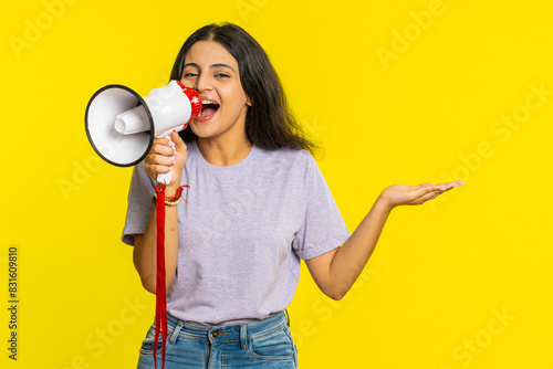 фотографія Indian young woman talking with megaphone, proclaiming news, loudly announcing advertisement discounts sale, using loudspeaker to shout speech
