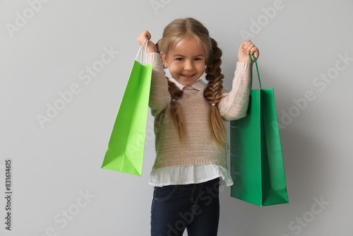 Happy little girl with shop...