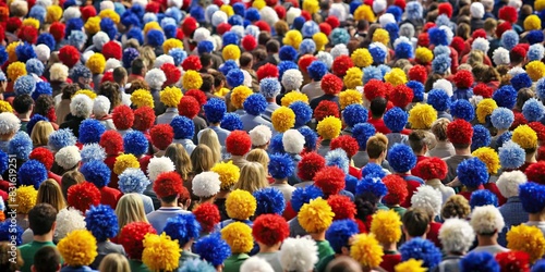 A sea of empty seats covered in team colors and pom poms, creating a lively and spirited atmosphere for cheering fans photo