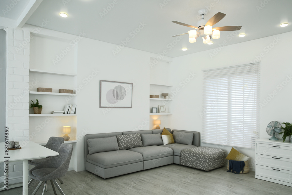 Comfortable furniture, ceiling fan and accessories in stylish living room