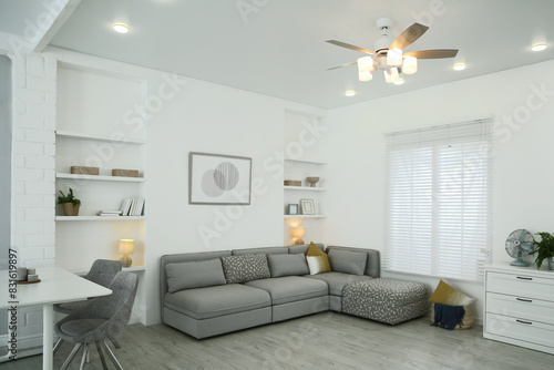 Comfortable furniture  ceiling fan and accessories in stylish living room