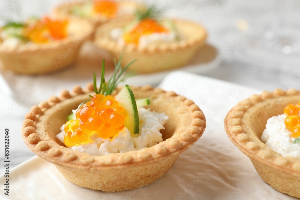 Delicious canapes with red caviar on table, closeup Delicious canapes with red caviar on table, closeup