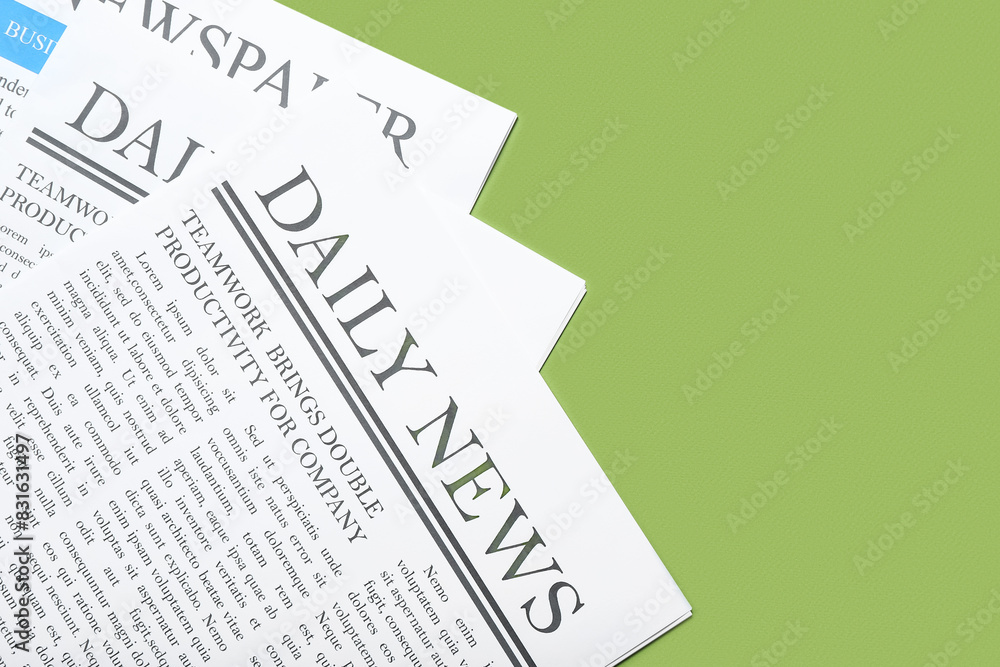 Naklejka premium Different newspapers on green background