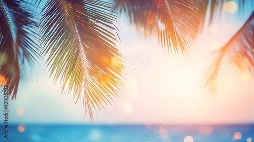 Abstract seascape with palm tree  tropical beach background. blur bokeh light of calm sea and sky. summer vacation background concept 