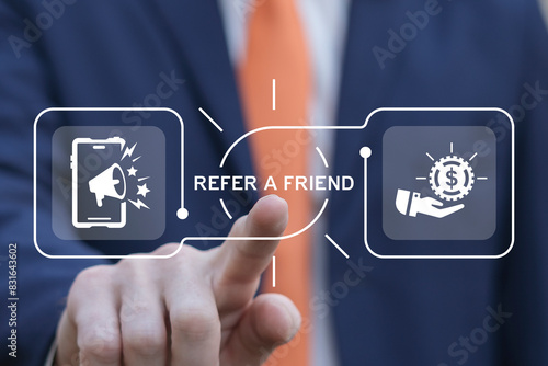 Obraz na płótnie Business man using virtual screen presses text: REFER A FRIEND. Referral marketing or affiliate marketing concept. Invite friends to refer a friend loyalty program to win online reward. Refer and earn w salonie