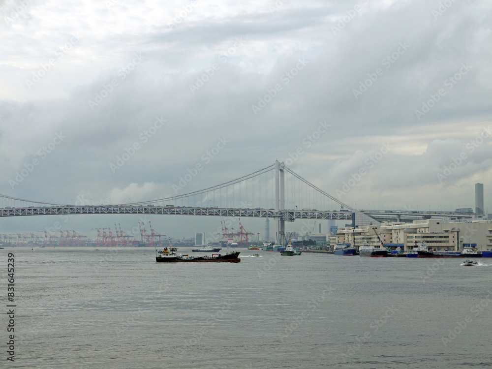 Rainbow Bridge and Tokyo bay view with cargo ship under the bridge Rainbow Bridge and Tokyo bay view with cargo ship under the bridge