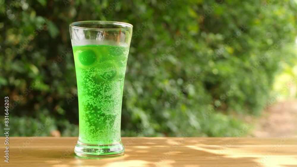Pour colorful soft drinks into glass bottles and place them on the table. Pour colorful soft drinks into glass bottles and place them on the table.