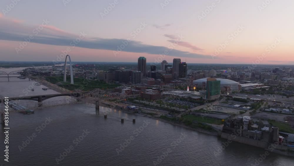 Aerial view of St. Louis, missouri at twilight. Includes the iconic gateway arch and Mississippi River. Cityscape and landmark of a travel destination Aerial view of St. Louis, missouri at twilight. Includes the iconic gateway arch and Mississippi River. Cityscape and landmark of a travel destination