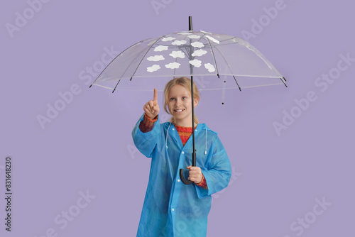Adorable girl in raincoat p...