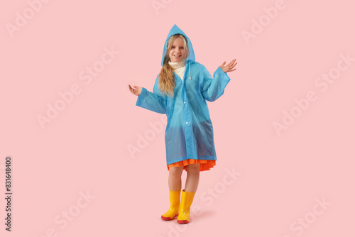 Adorable girl in raincoat a...