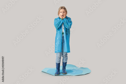 Surprised girl with raincoa...