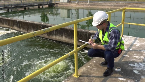 Service engineer checking on waste water treatment plant,Environmental engineers inspect quality at water plants,Technicians work at a water station to produce tap water.