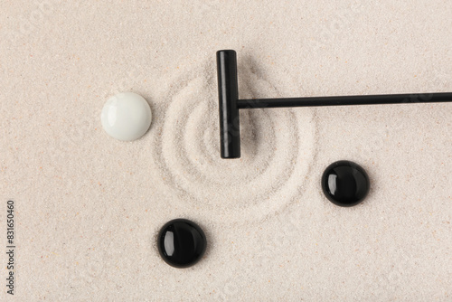Photography Rake and stones on sand with lines in Japanese rock garden, top view