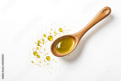 Wooden spoon with olive oil and drops