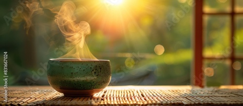 Morning Serenity A Steaming Cup of Green Tea Bathed in Natural Light photo