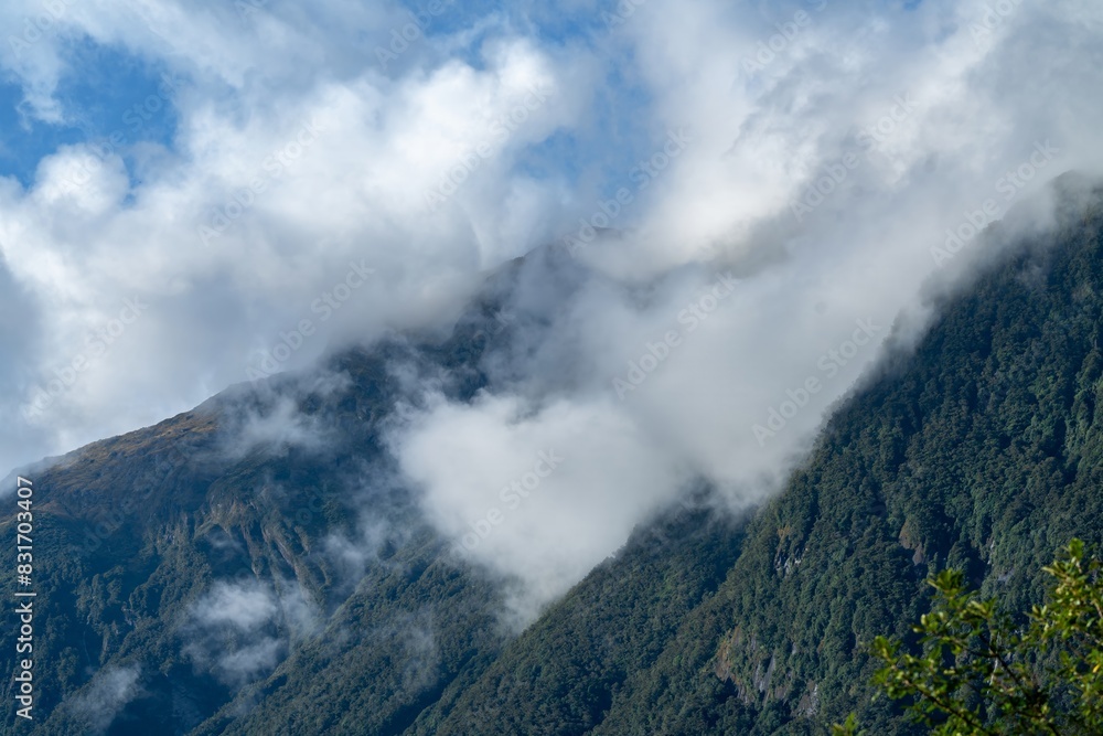 Clouds on the mountains in the Southern Alps. Haast, West Coast, New Zealand. Clouds on the mountains in the Southern Alps. Haast, West Coast, New Zealand.