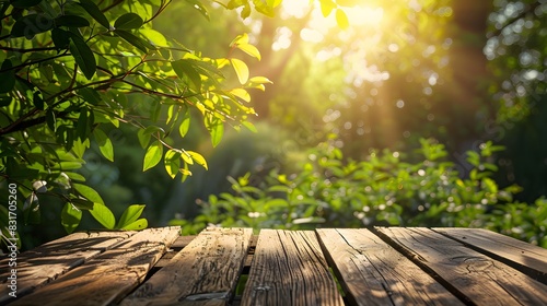 Sunlit green foliage forming a stunning spring-summer natural background with an empty wooden table outdoors