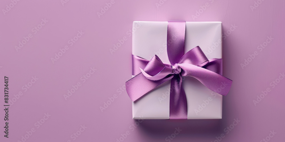 An elegant gift box tied with a purple ribbon sits on a soft lavender background. An elegant gift box tied with a purple ribbon sits on a soft lavender background.