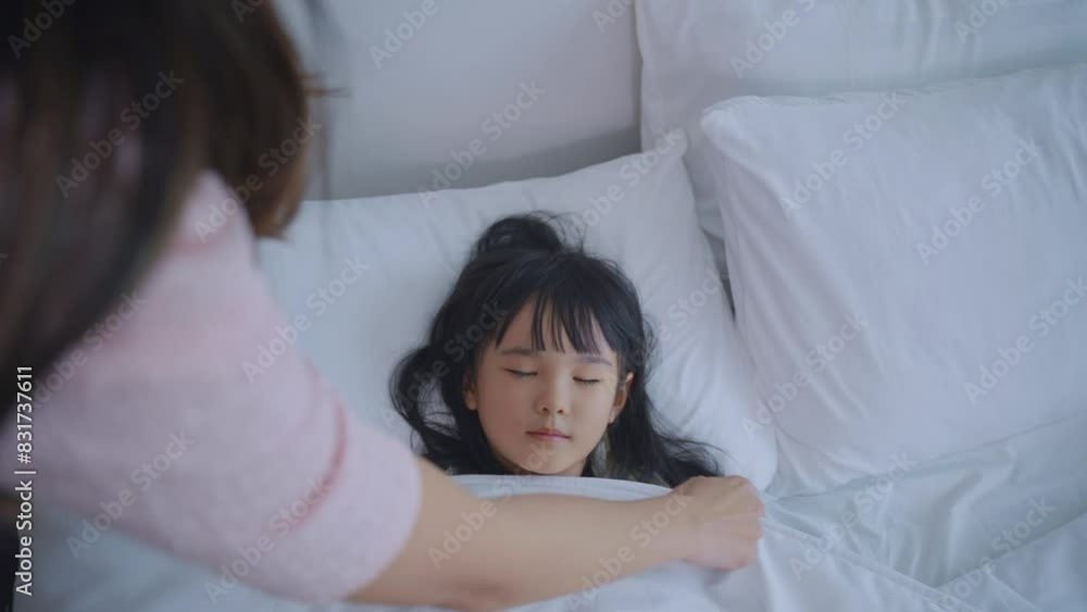 Asian loving mother take care of sleeping daughter in bedroom at home. Asian loving mother take care of sleeping daughter in bedroom at home.