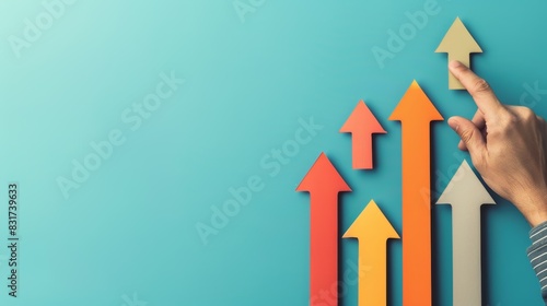 Hand pointing at multicolored arrows growing over blue background. Concept of growth, progress, success, and achievement in business and finance.
