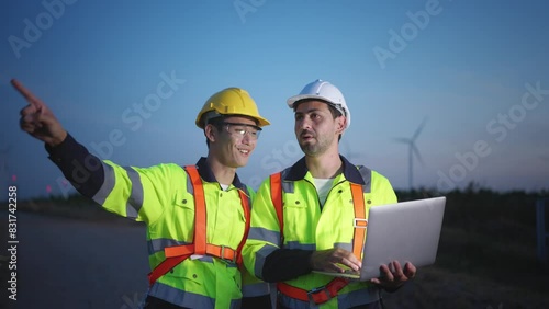 Diverse ethnicity male technicians working in the wind turbines field.