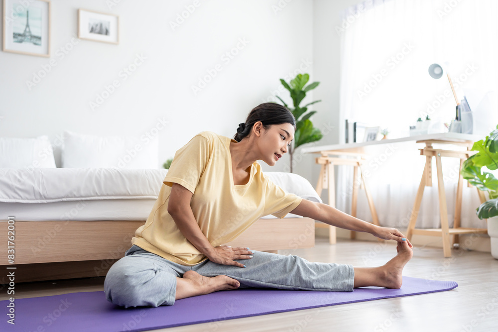 Fototapeta premium Asian young beautiful sportswoman doing yoga pilates workout at home.