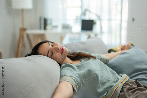 Asian beautiful girl lying down on comfort sofa in living room at home. 