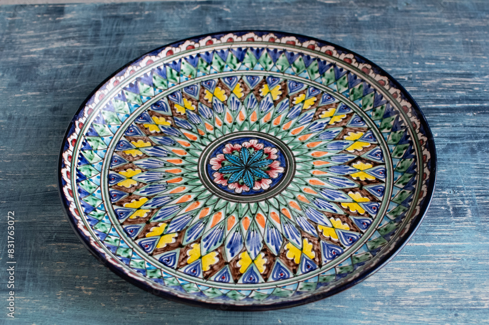 Beautiful hand painted blue ceramic dish with ornament in Central Asian style. Beautiful hand painted blue ceramic dish with ornament in Central Asian style.