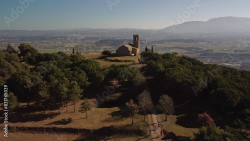 The hermitage of tona surrounded by trees and overlooking a town in barcelona, aerial view photo