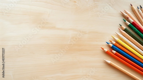 Top view of a few colored pencils around on wooden table. Education, learning, back to scholl concept. Space for copy text