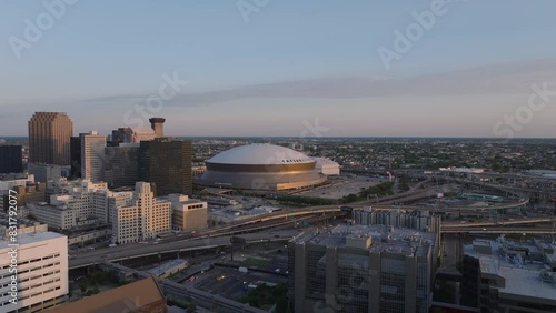 Enchanting cityscape of downtown new orleans at twilight, featuring iconic architecture, Caesars Superdome and the vibrant city life at dusk