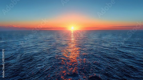   The sun appears to be sinking into the horizon as viewed from a floating vessel amidst an oceanic expanse during midday photo