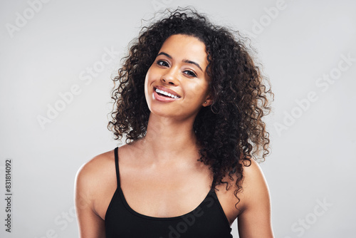 Portrait, relax and woman with hair care in studio for salon treatment, shine and satisfaction. Happy, female person and smile with pride for shampoo, growth and curly hairstyle on white background