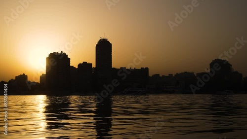 Golden sunset over the Nile River with the Cairo, Egypt skyline background photo