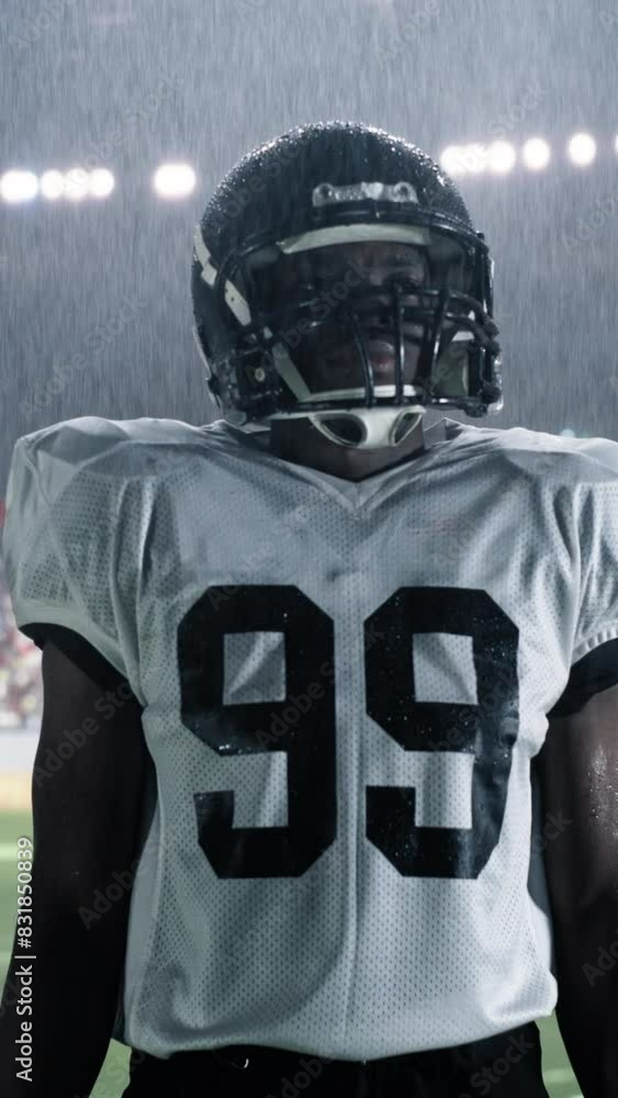 Vertical Screen: African American Football Player, Celebrating on the Field Under Stadium Lights in Rain. Intense and Inspirational Sports Footage with Dramatic Lighting and Weather Conditions Vertical Screen: African American Football Player, Celebrating on the Field Under Stadium Lights in Rain. Intense and Inspirational Sports Footage with Dramatic Lighting and Weather Conditions
