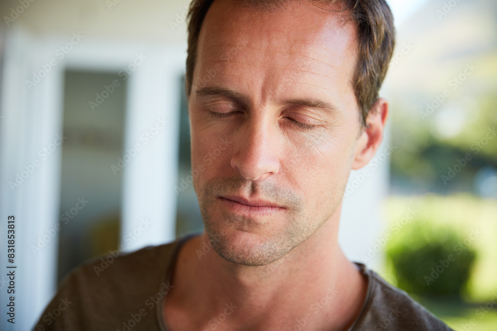 Obraz premium Man, serious and meditation with relax outdoor for eyes closed, mindfulness and spiritual wellness in morning. Person, calm and zen with resting in home for fresh air, peaceful and mental health