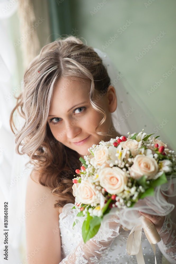 Naklejka premium Morning of bride in white dress and elegant hairstyle. A young attractive, happy girl posing with luxurious bouquet. Happiness, purpose and dream wedding. Vertical image.