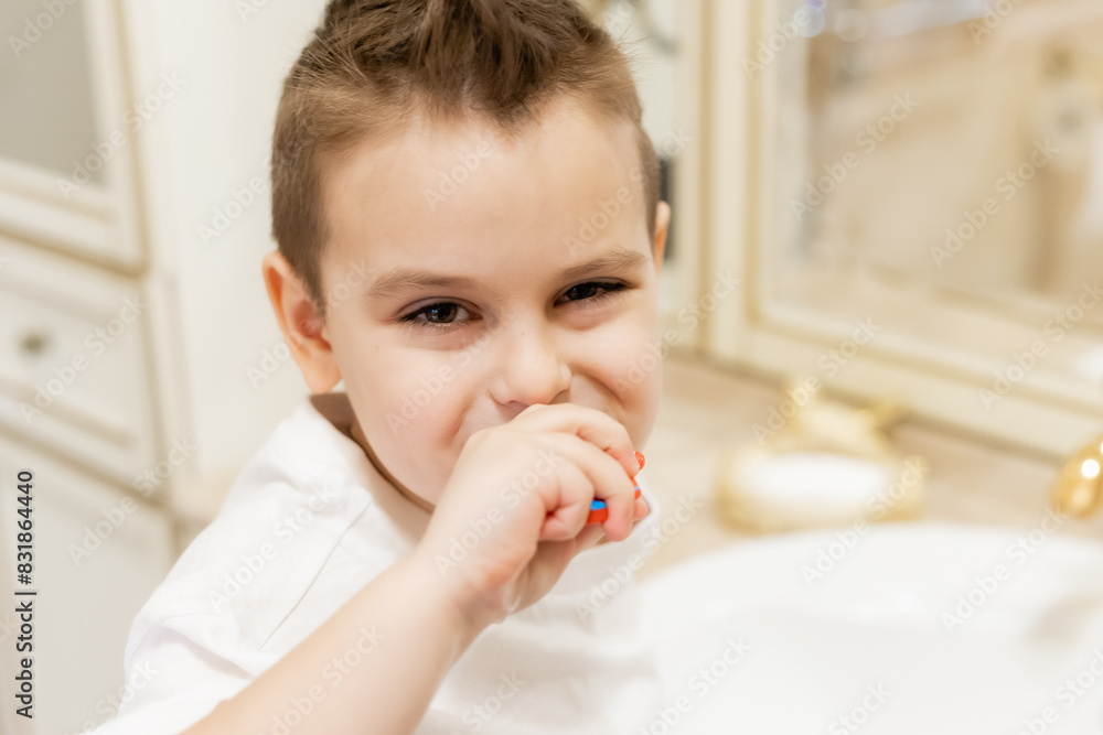 little boy brushes his teeth in the bathroom at home little boy brushes his teeth in the bathroom at home