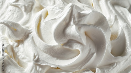 A close up of a white frosting swirl. The frosting is thick and creamy  with a slight hint of vanilla. The swirls are intricate and delicate  giving the impression of a work of art
