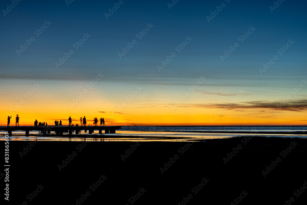 Naklejka premium Sea shore scenic tourist pathway bridge under sunset glow with rosy clouds. Gaomei Wetlands, Taichung City, Taiwan