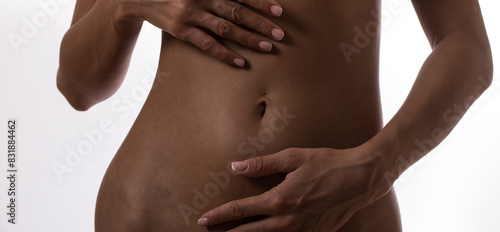 Woman applying body cream to her stomach